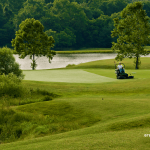 Panoramic view of a lush green golf course at The Golf Club at Deer Chase. Smooth