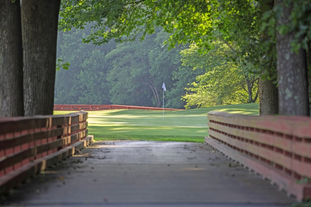 Panoramic view of a lush green golf course at The Golf Club at South River. Smooth