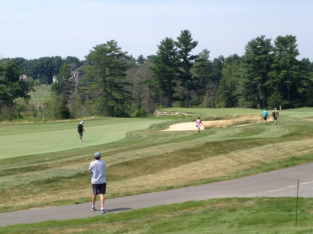 Panoramic view of a lush green golf course at The Golf Club of New England. Smooth