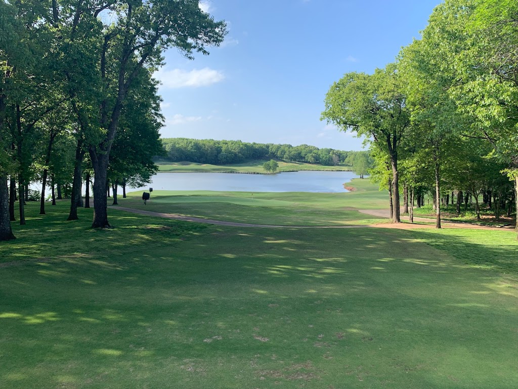 Panoramic view of a lush green golf course at The Golf Club of Oklahoma. Smooth