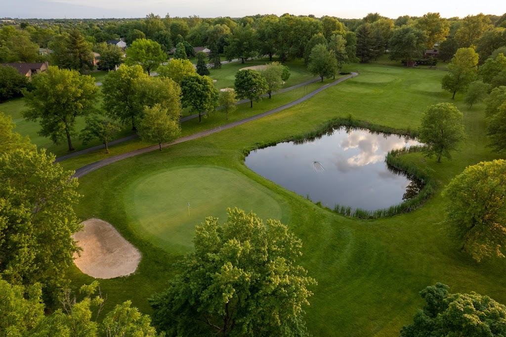 Panoramic view of a lush green golf course at The Grizzly Golf and Social Lodge. Smooth