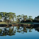 Panoramic view of a lush green golf course at The Habitat Golf Course. Smooth