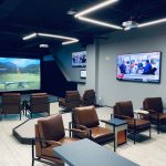 Panoramic view of a lush green golf course at The Hack Shack. Smooth