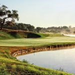 Panoramic view of a lush green golf course at The Harvester Club. Smooth