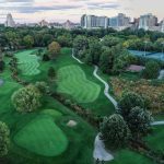 Panoramic view of a lush green golf course at The Highlands Golf & Tennis. Smooth