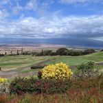 Panoramic view of a lush green golf course at The King Kamehameha Golf Club. Smooth