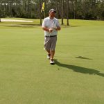 green grass with the flag in the hole.