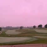 Panoramic view of a lush green golf course at The Legacy Golf Club. Smooth