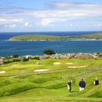 Panoramic view of a lush green golf course at The Links at Bodega Harbour. Smooth