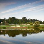 Panoramic view of a lush green golf course at The Links at Challedon. Smooth