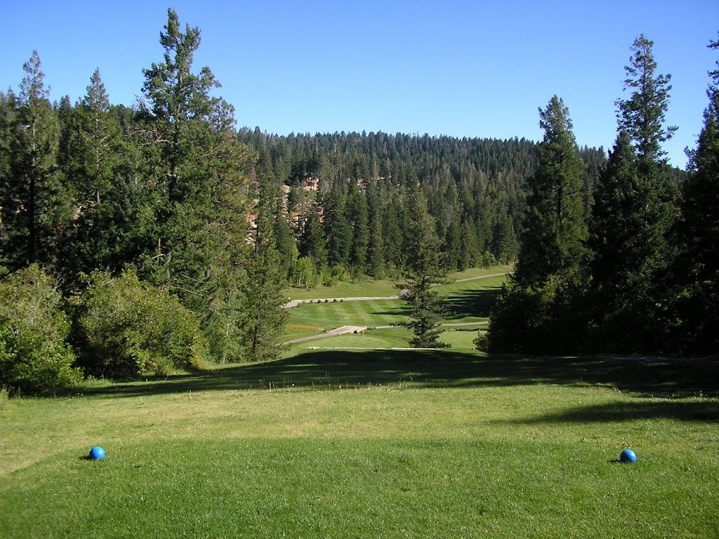 Panoramic view of a lush green golf course at The Lodge Golf Course. Smooth