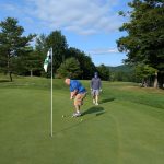 green grass with the flag in the hole.