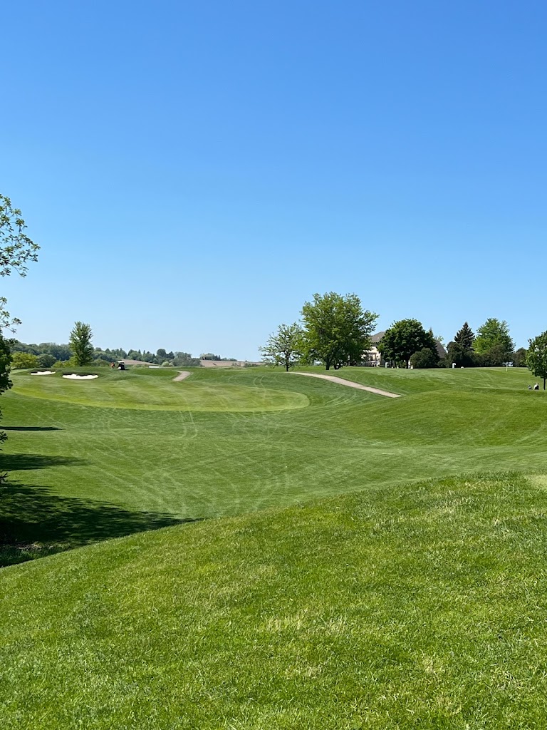 Panoramic view of a lush green golf course at The Meadows Golf Club. Smooth