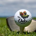 Panoramic view of a lush green golf course at The Oaks Golf Course at Margaritaville Lake Resort. Smooth