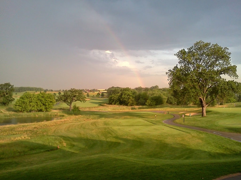 Panoramic view of a lush green golf course at The Oaks Golf Course. Smooth