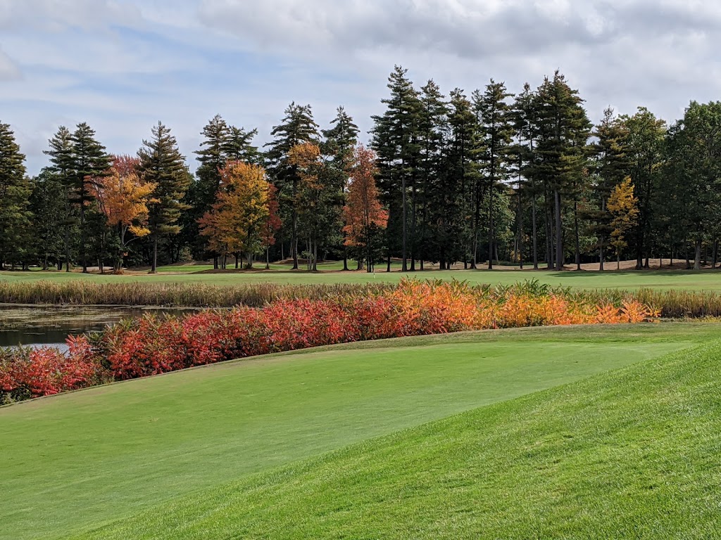 Panoramic view of a lush green golf course at The Oaks. Smooth