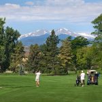 Panoramic view of a lush green golf course at The Olde Course at Loveland. Smooth