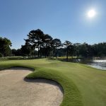 Panoramic view of a lush green golf course at The Ole Miss Golf Course. Smooth