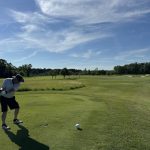 green grass with the flag in the hole.