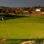 Panoramic view of a lush green golf course at The Orchards Golf Club. Smooth