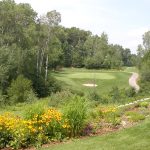 Panoramic view of a lush green golf course at The Patriot Golf Course. Smooth