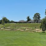 Panoramic view of a lush green golf course at The Pfau Course. Smooth