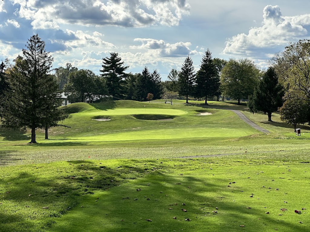 Panoramic view of a lush green golf course at The Pines Country Club. Smooth