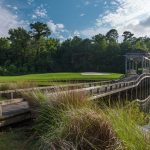 Panoramic view of a lush green golf course at The Pointe Golf Club. Smooth