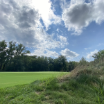 Panoramic view of a lush green golf course at The Preserve at Eisenhower. Smooth