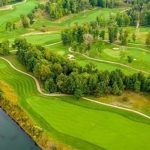 Panoramic view of a lush green golf course at The Quarry Golf Club & Venue. Smooth