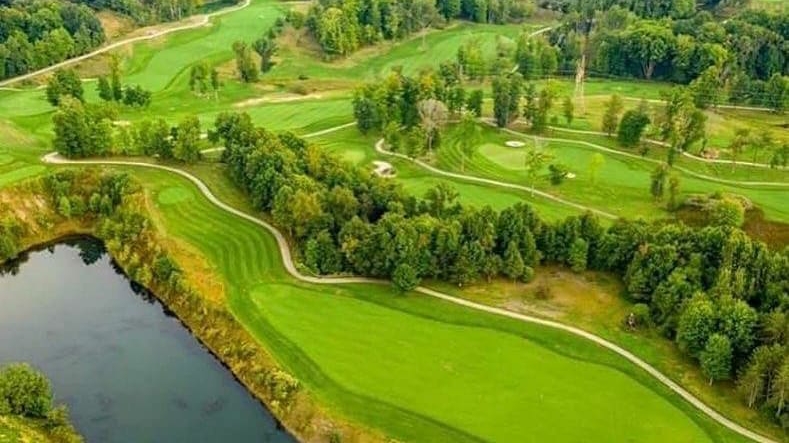 Panoramic view of a lush green golf course at The Quarry Golf Club & Venue. Smooth