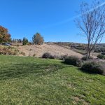 Panoramic view of a lush green golf course at The Ranch Golf Club. Smooth