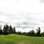 Panoramic view of a lush green golf course at The Reserve Vineyard & Golf Club. Smooth