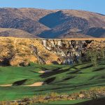 Panoramic view of a lush green golf course at The Revere Golf Club. Smooth