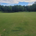 Panoramic view of a lush green golf course at The Ridges at Village Creek. Smooth