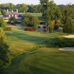 Panoramic view of a lush green golf course at The River Golf Club. Smooth