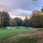 Panoramic view of a lush green golf course at The Shattuck Golf Club. Smooth