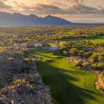 Panoramic view of a lush green golf course at The Stone Canyon Club. Smooth