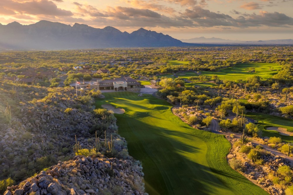 Panoramic view of a lush green golf course at The Stone Canyon Club. Smooth