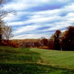 Panoramic view of a lush green golf course at The Timbers At Troy. Smooth