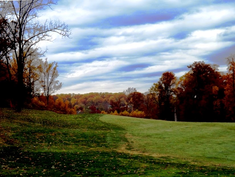 Panoramic view of a lush green golf course at The Timbers At Troy. Smooth