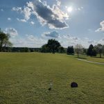 Panoramic view of a lush green golf course at The University Club at Arlington. Smooth