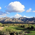 Panoramic view of a lush green golf course at The Views Golf Club. Smooth