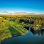 Panoramic view of a lush green golf course at The Village Course at Waikoloa. Smooth