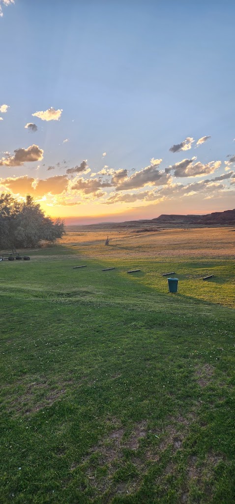 Panoramic view of a lush green golf course at Thermopolis Golf Course. Smooth