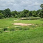 Panoramic view of a lush green golf course at Thorntree Golf Club. Smooth