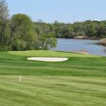 green grass with the flag in the hole.