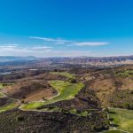 Panoramic view of a lush green golf course at Tierra Rejada Golf Club. Smooth