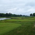 Panoramic view of a lush green golf course at Tiffany Greens Golf Club. Smooth