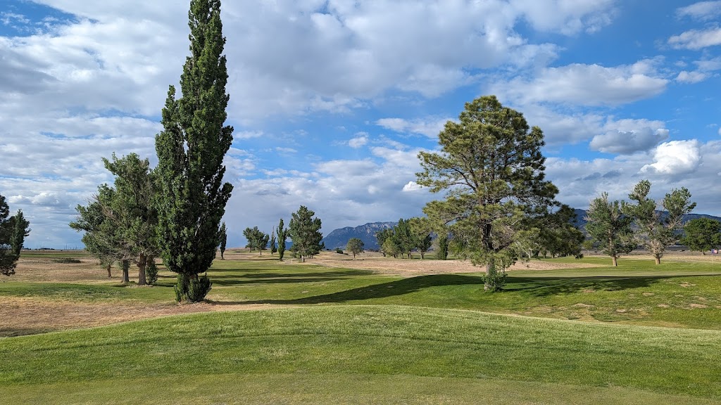 Panoramic view of a lush green golf course at Tijeras Arroyo Golf Course. Smooth